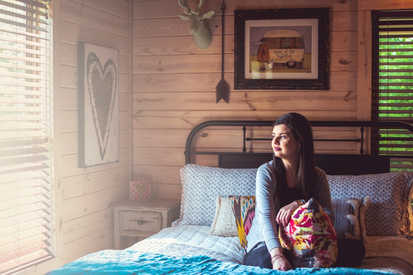 Cozy sunlit bedroom with warm wood paneling and soft window light, an example of a simple at-home background